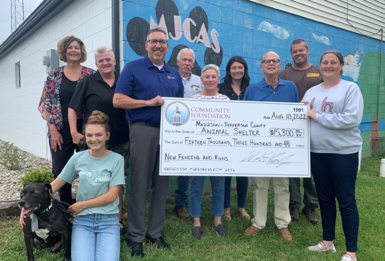 The Community Foundation of Madison & Jefferson County (CFMJC) presented a $15,300 grant to the Madison-Jefferson County Animal Shelter (MJCAS) on August 10, 2022.  On hand for the presentation were: Front Row: (from left) Albert the dog (available for adoption); Jessica Sherman, MJCAS employee; Bill Barnes, CFMJC President & CEO; and Lindsay Stultz, MJCAS Executive Director. Middle Row: (from left) Janet Daugherty, City Animal Control Officer; and Alice Carlson-Jackson & Jim Jackson, Spirit’s Fund Founders. Back Row: (from left) Stephanie Withered, CFMJC Board Chair; Robert Little, Jefferson County Commissioner; Hannah Fagen, MJCAS Advisory Board Secretary; and Paul Geyman, County Animal Control Officer. (Photo Courtesy of CFMJC)